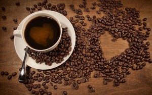 a-cup-of-coffee-coffee-beans-placed-heart-shaped-pattern_1680x1050